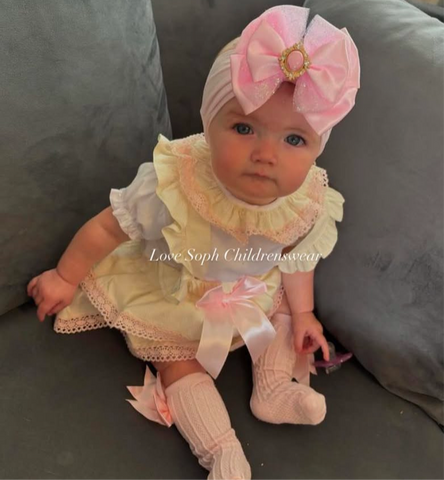 Luxe cream pinafore dress with frilly blouse and bows
