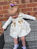 Stunning luxury puffball coat with bows and detailing on back